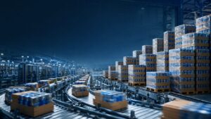 holiday spike co packing - Korpack - Packaging Solutions for Complex Businesses Warehouse with stacked pallets of boxed goods on a curved conveyor line