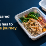 Fresh Meals Strong Packaging - Korpack - Packaging Solutions for Complex Businesses Hero image showing a sealed plastic meal tray with sliced grilled chicken, broccoli, and roasted vegetables on a dark blue background; includes the text 'Fresh prepared meals: the packaging has to survive the journey.'