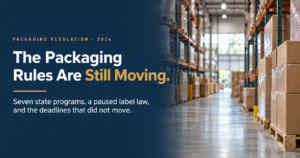Packaging Rules in Motion - Korpack - Packaging Solutions for Complex Businesses Hero banner: dark blue panel with the headline 'The Packaging Rules Are Still Moving.' beside a warehouse full of stacked boxes and pallets on the right.